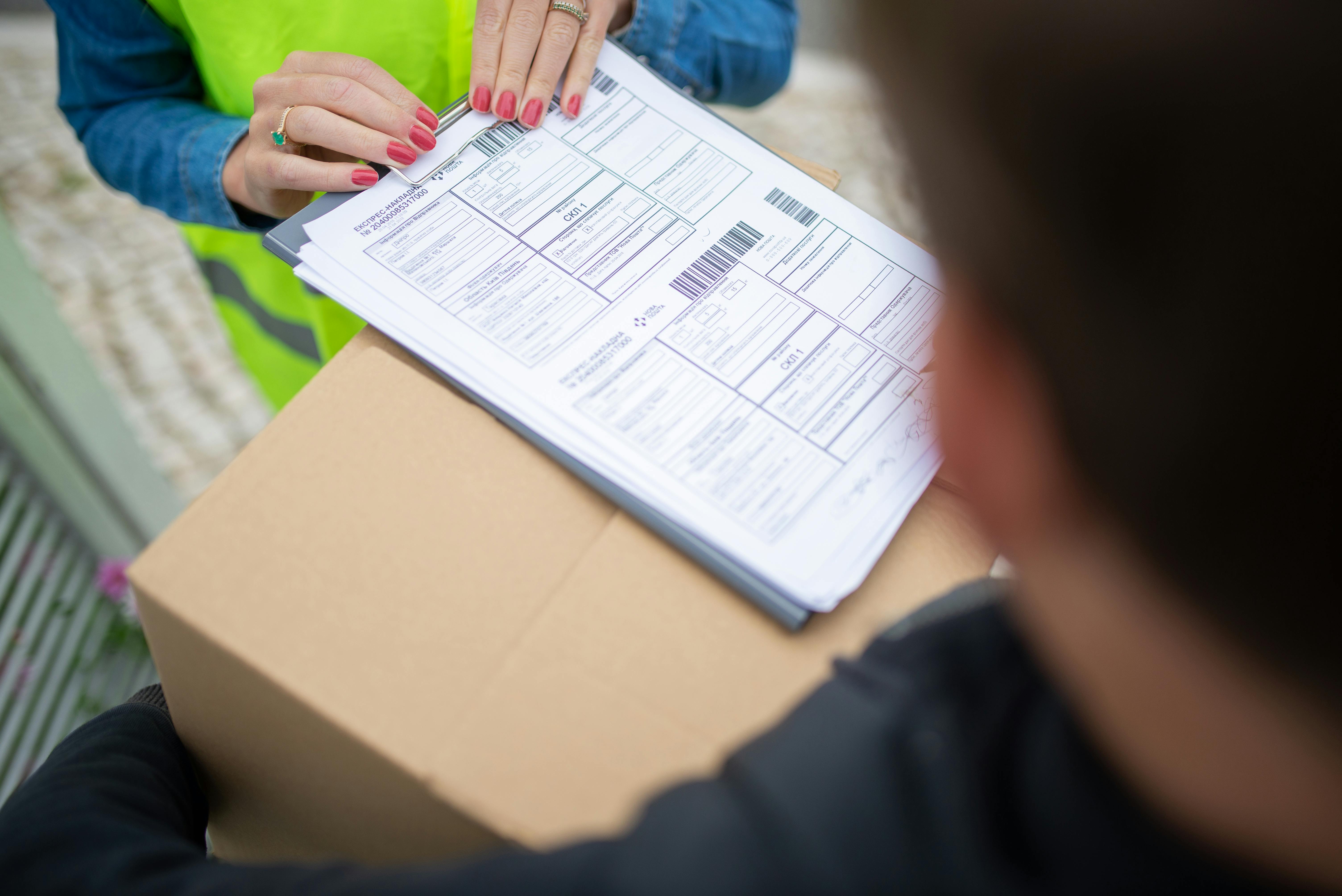 Dispatch paperwork being checked over a parcel