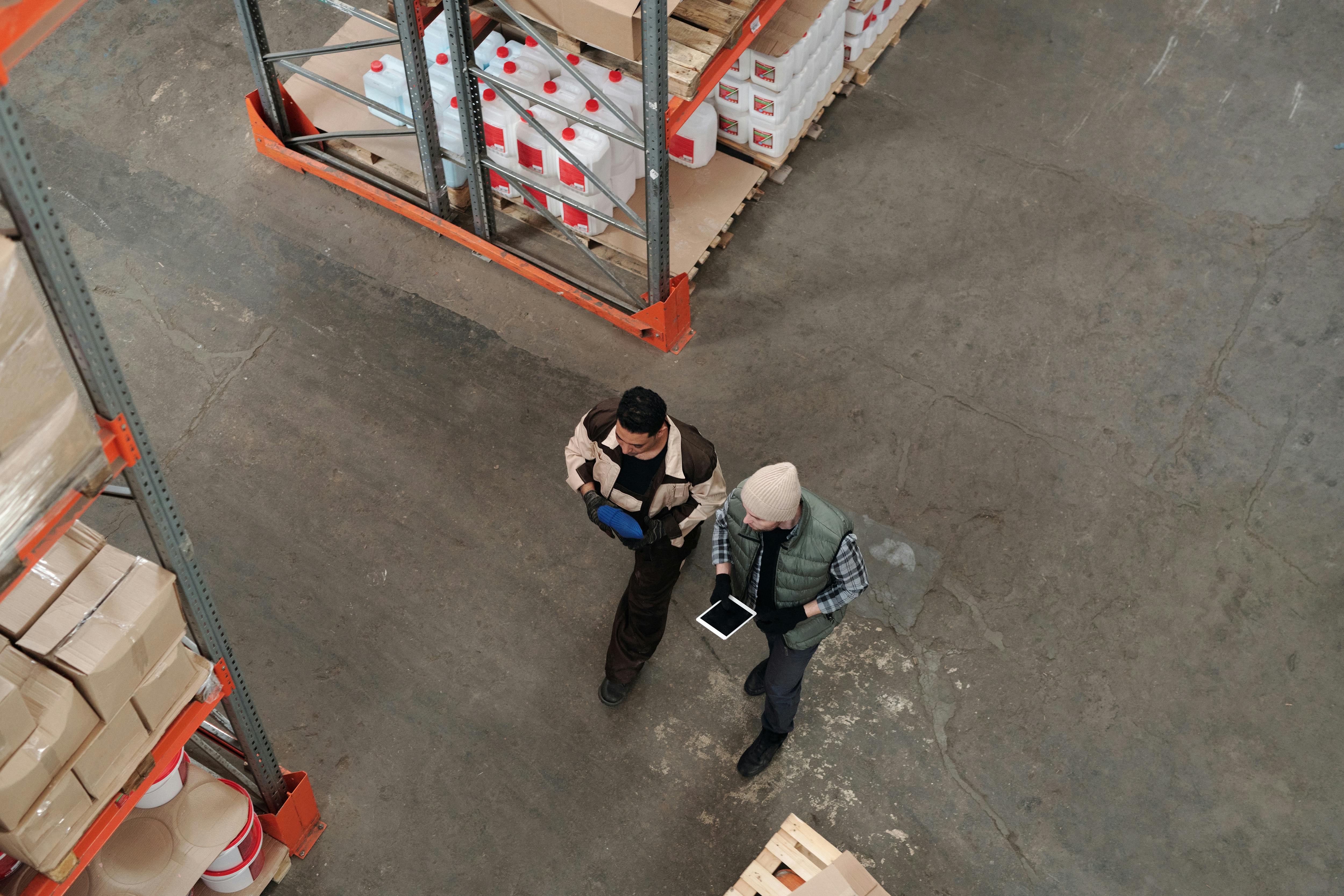 Warehouse team coordinating inventory with a tablet